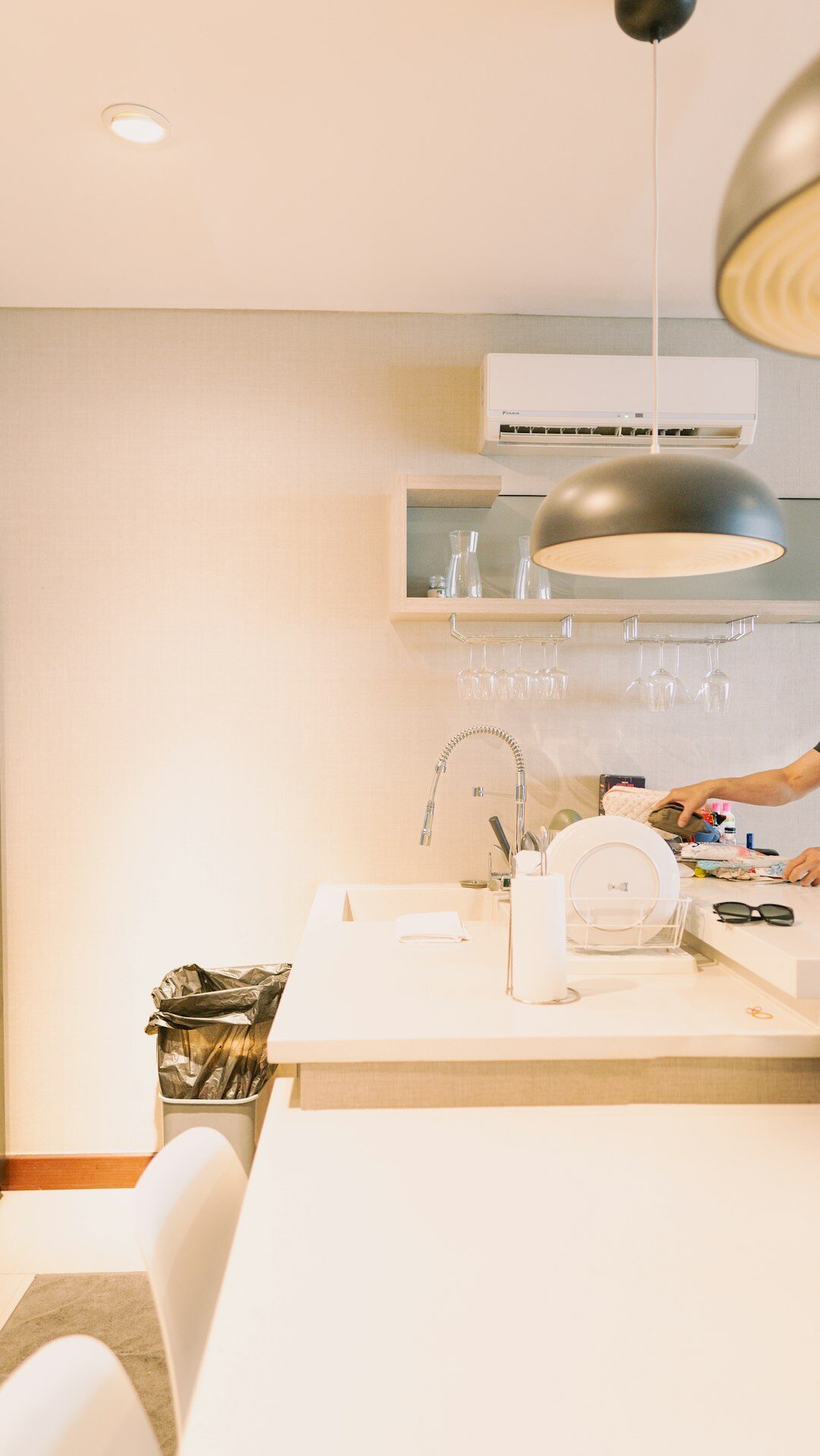person wiping kitchen counter